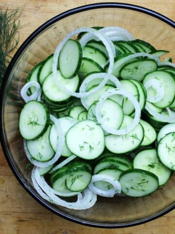 Cucumber salad with dill in a glass bowl