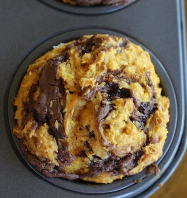 Pumpkin nutella muffin with the nutella swirled through the baked pumpkin muffin.