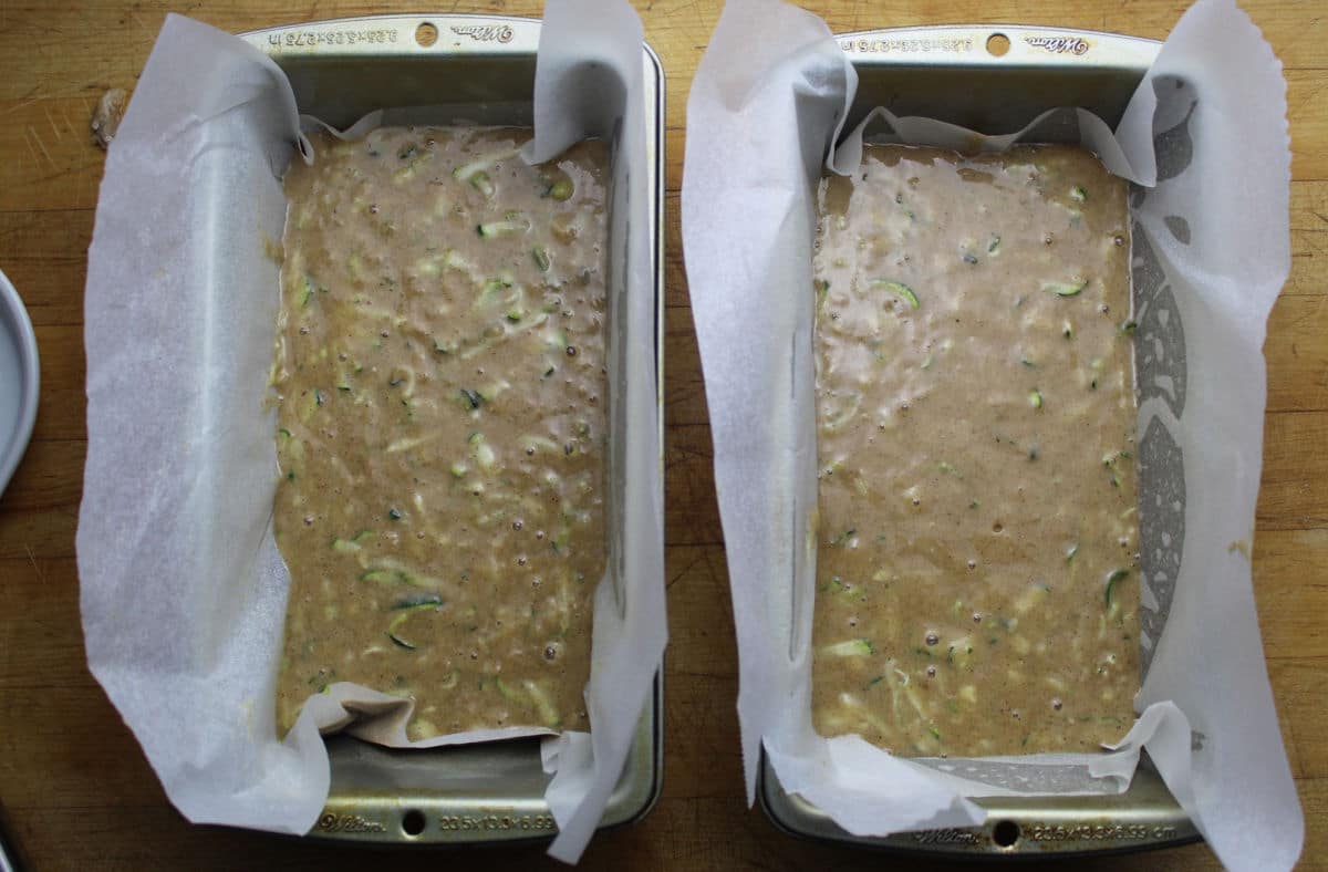 Zucchini bread batter in two loaf pans, ready for the oven. 