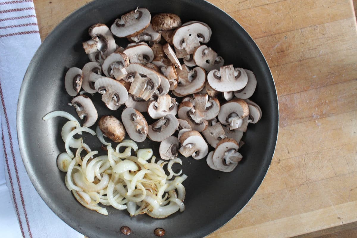 sautéed mushrooms and onions in a pan. 