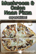 mushroom and onion naan pizza with melted cheese on a baking pan.