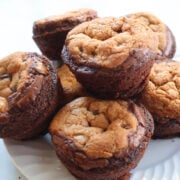 Brookies on a white plate. Brookies are brownie on the bottom, cookies on the top. Baked in a muffin tin.