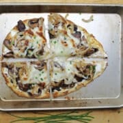 flatbread with sauteed onions and mushrooms with melted cheese.