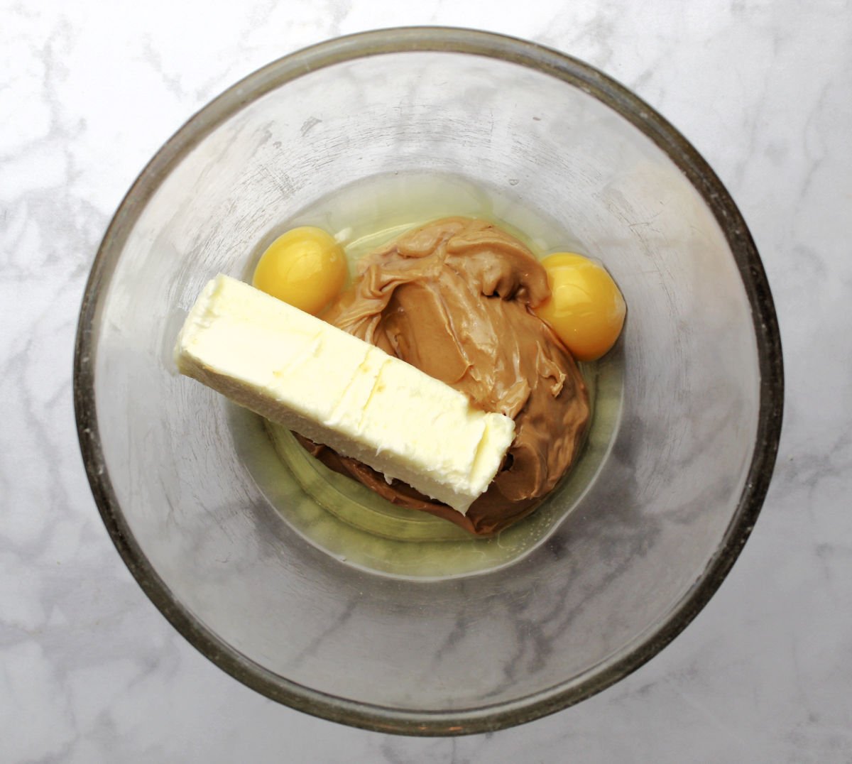 mixing wet ingredients of peanut butter, eggs and butter for the cake mix peanut butter cookie recipe