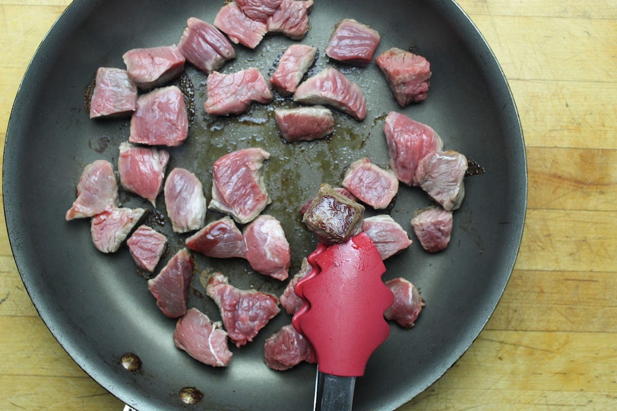 beef in a frying pan browning.