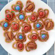 Red white and blue M&Ms on melted Hershey Kisses over pretzels