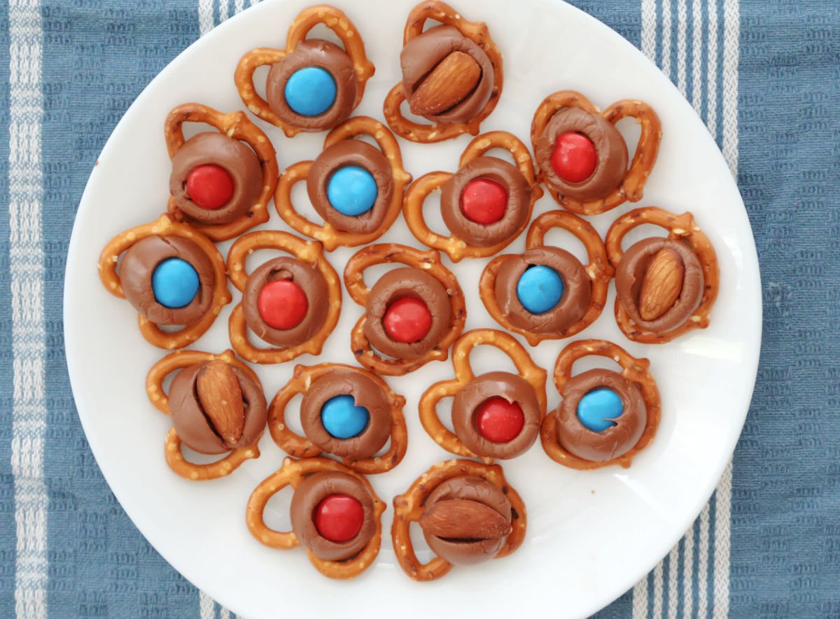 Red white and blue M&Ms on melted Hershey Kisses over pretzels