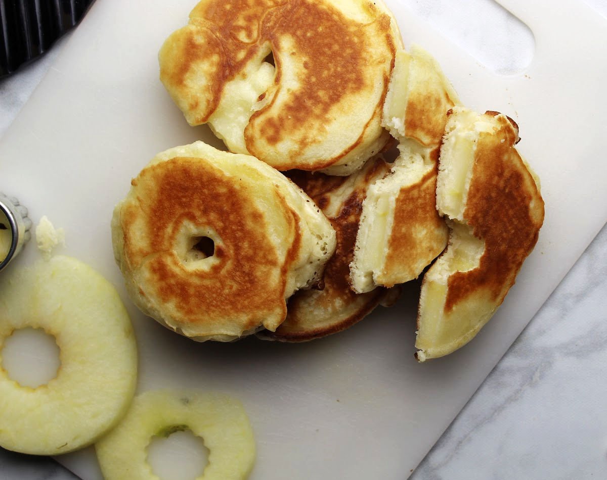 pancake batter covered apple rings beside slices or apple rings.