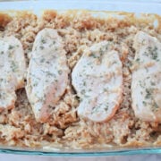 4 pieces of cooked and seasoned chicken pieces on top of cooked and creamy seasoned rice