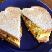 A toasted Western Egg Sandwich on a blue plate