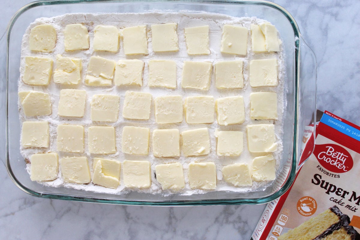 slices of butter on top of the cake mix layer.