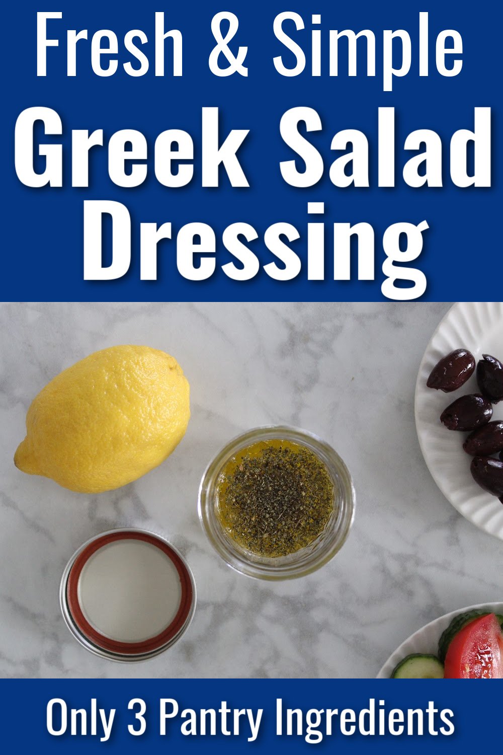 A jar of greek salad dressing with a lemon, olives and sliced tomato at the side. Text overlay states fresh and simple greek salad dressing.