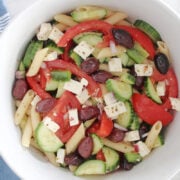 Greek Pasta salad with cut up tomoatoes, cucumbers, feta, red onions, olives and a fresh oregano, lemon with olive oil dressing.