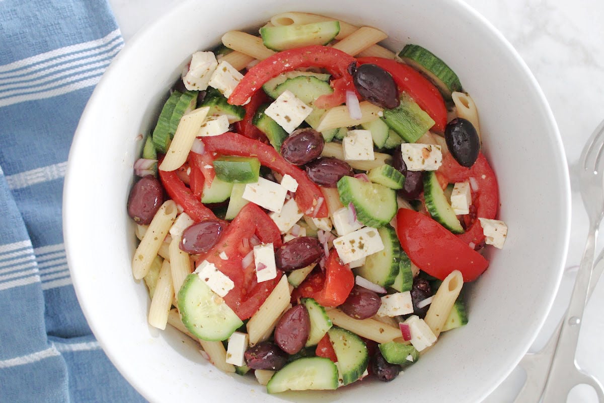 Greek Pasta salad with cut up tomoatoes, cucumbers, feta, red onions, olives and a fresh oregano, lemon with olive oil dressing.