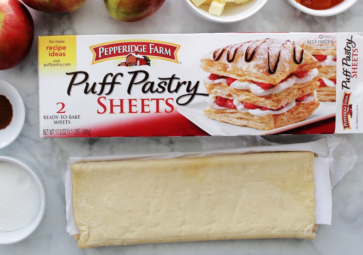 one puff pastry sheet taken out of the box.  It is rolled in ⅓s and has parchment paper between layers.