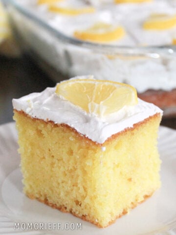Lemon poke cake with a lemon slice garnish.