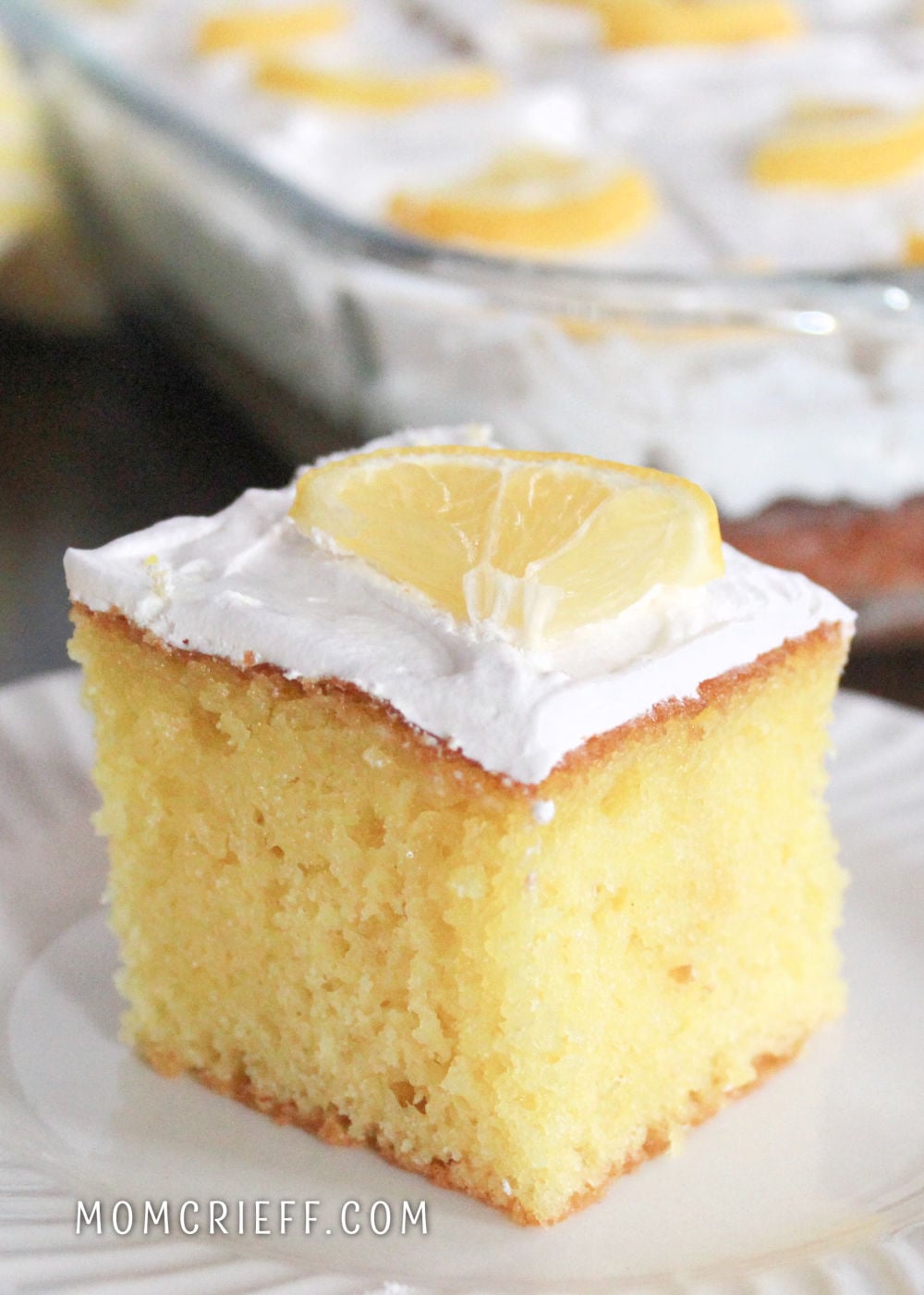 Lemon poke cake with a lemon slice garnish.