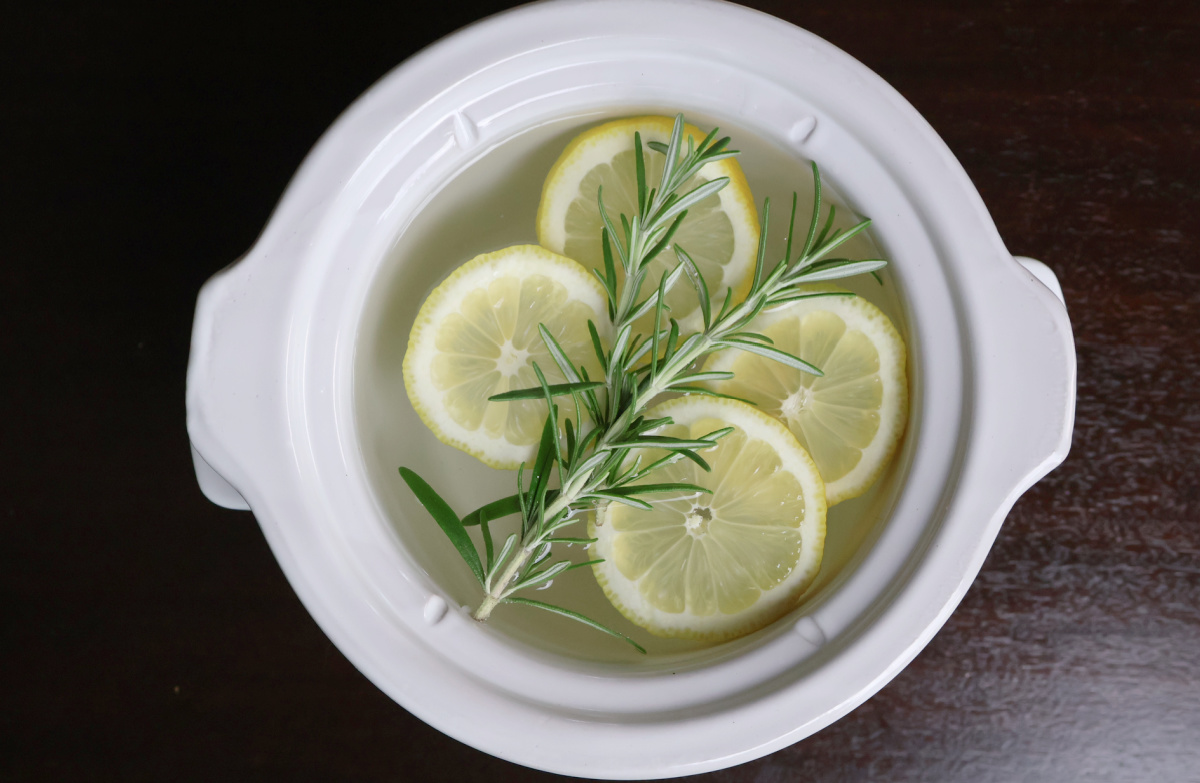 Summer Simmer Pot with lemon slices and rosemary sprigs floating on clear water.