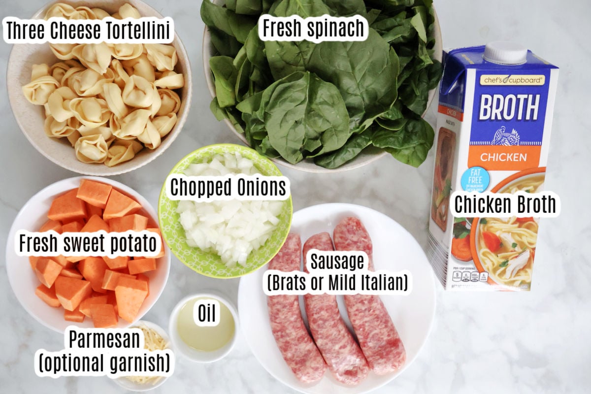 Ingredients for sausage spinach tortellini soup including chicken stock, spinach, sausage, tortellini, sweet potato.