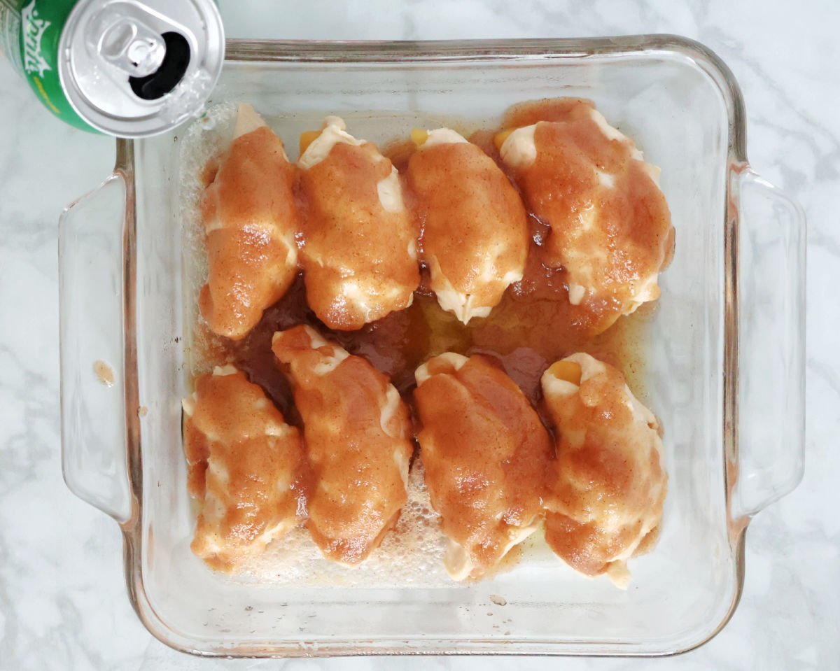 adding sprite to the sauce covered peach dumplings.