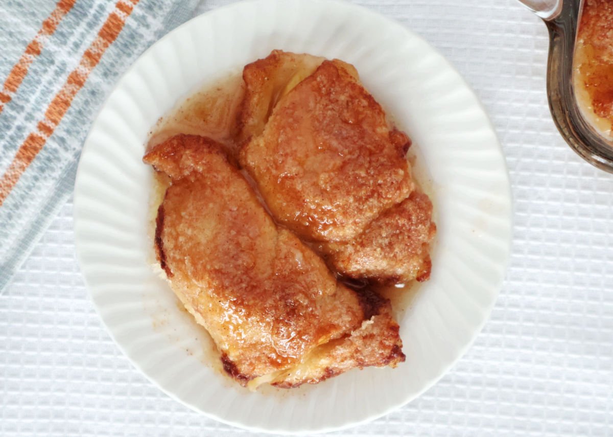 two peach dumplings with a light coating of a sweet buttery sauce.