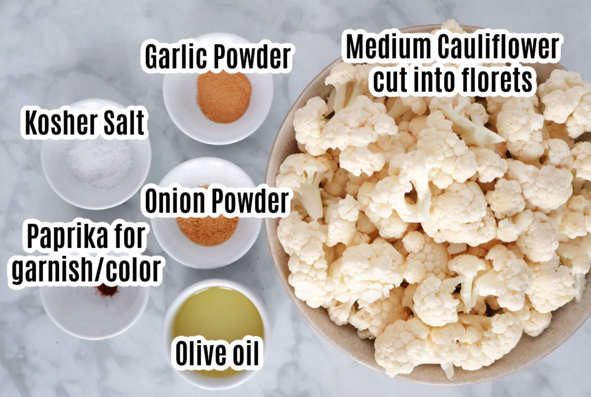 Ingredients for seasoned cauliflower includes cauliflower florets, garlic and onion powder, oil, salt and paprika.