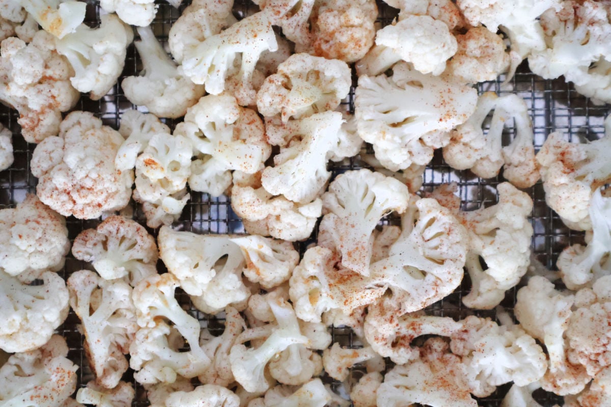 Cauliflower spread on an air fryer tray 