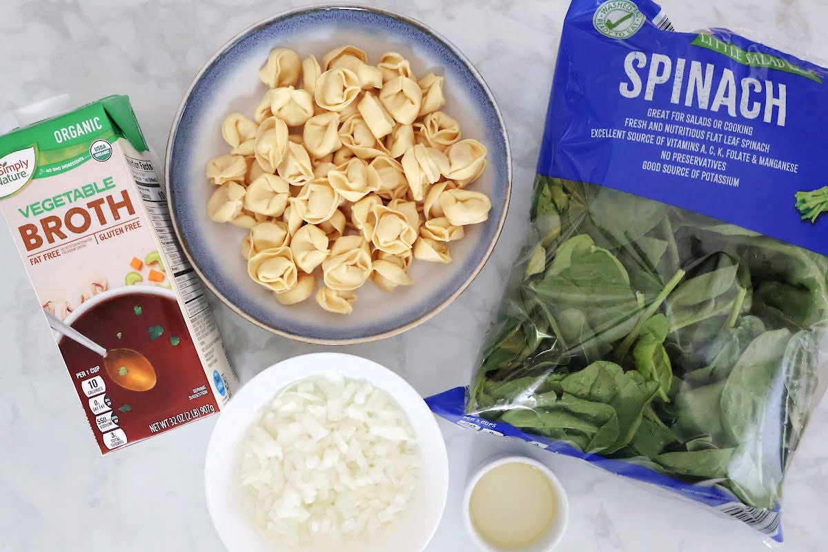 Ingredients to this spinach tortellini souop include 1 small onion, vegetable broth, refrigerated cheese tortellini and a bag of fresh spinach.