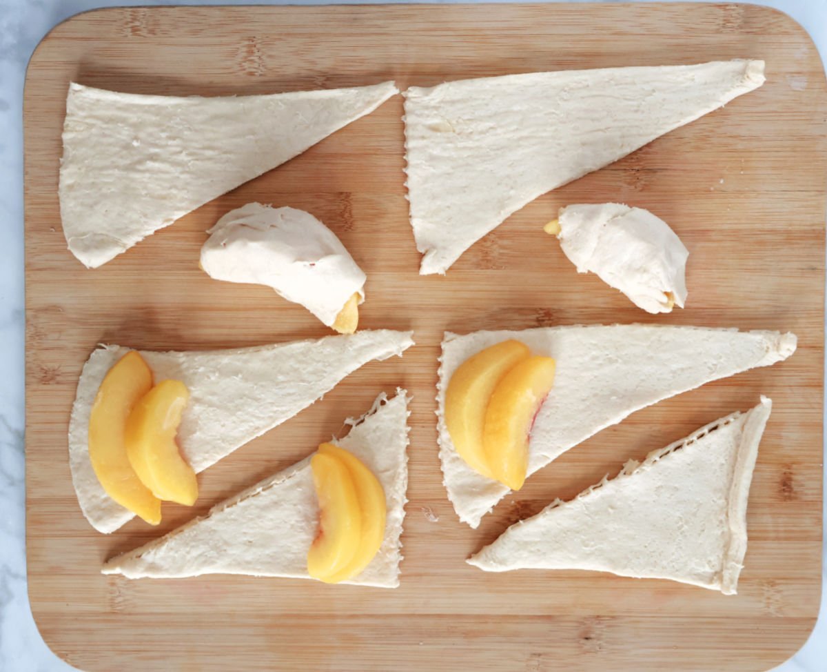 wrapping 2 slices in each triangle of crescent dough.