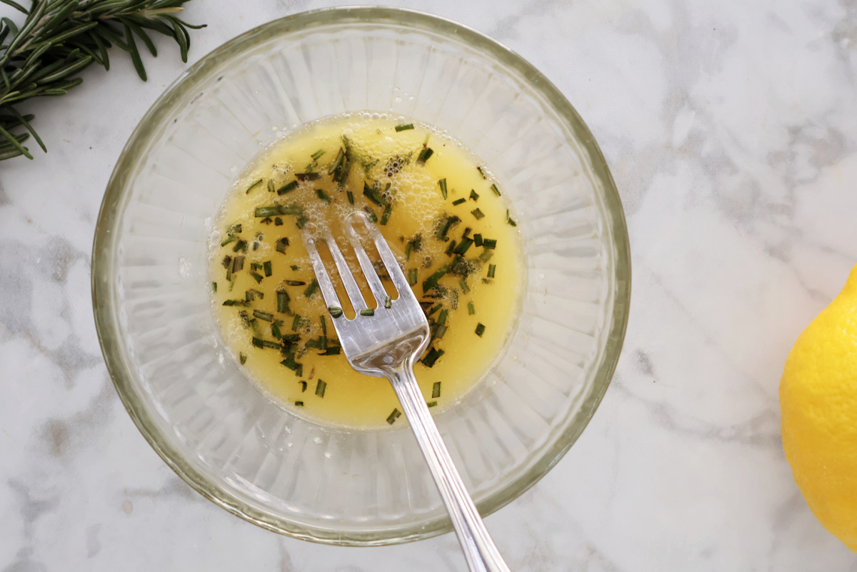 In a small bowl, add melted butter, chicken broth, lemon juice and minced rosemary. 