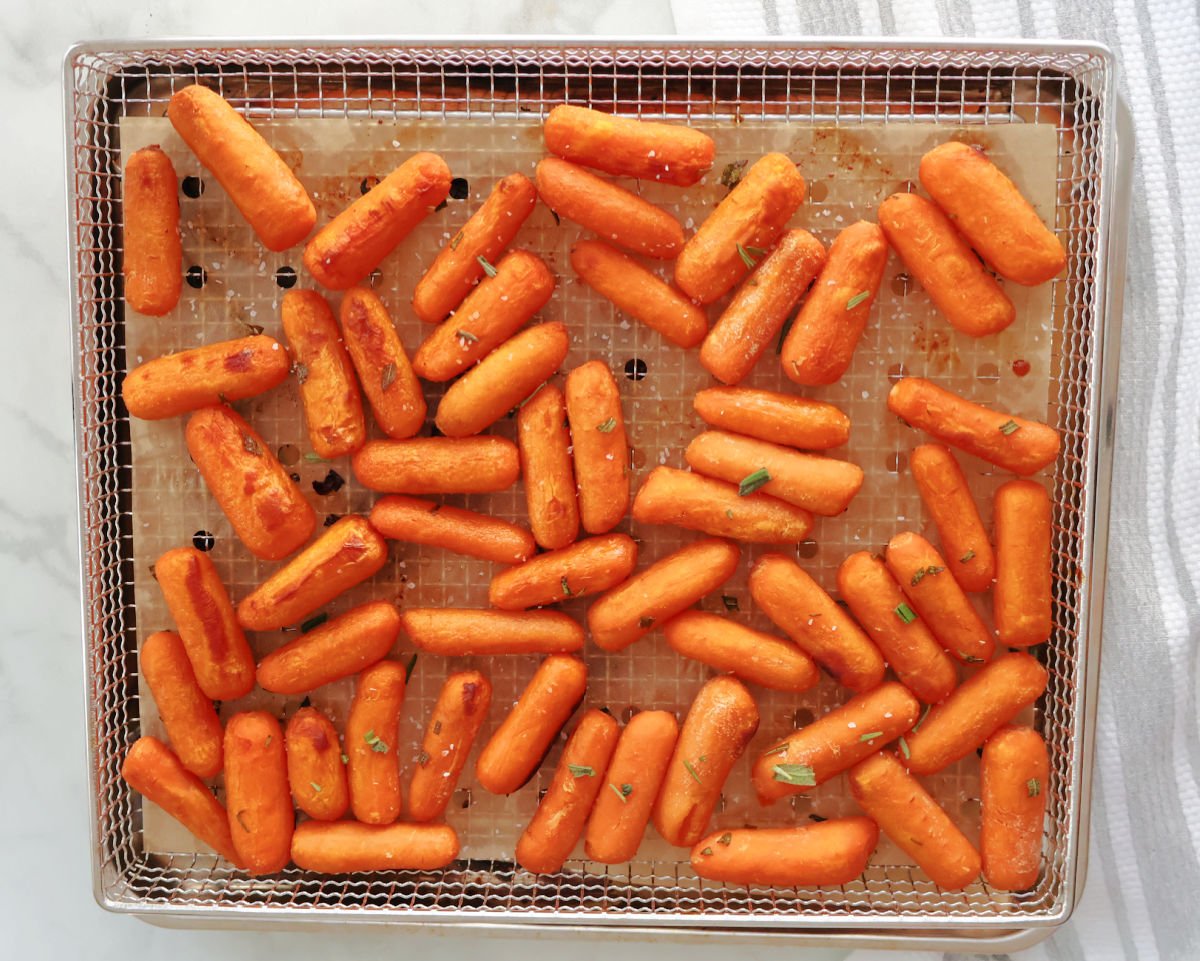 roasted baby carrots in an air fryer basket