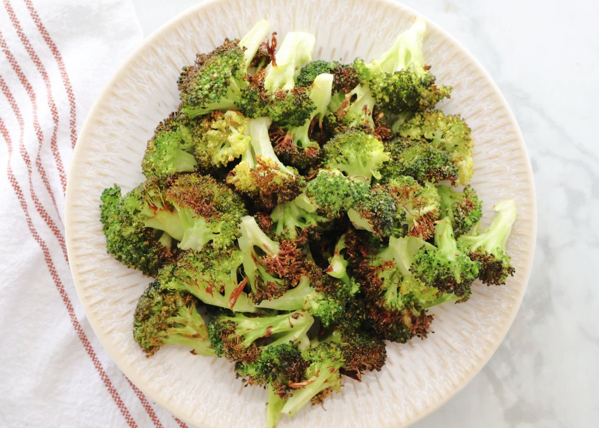 Air Fried broccoli with just a little char on a plate.