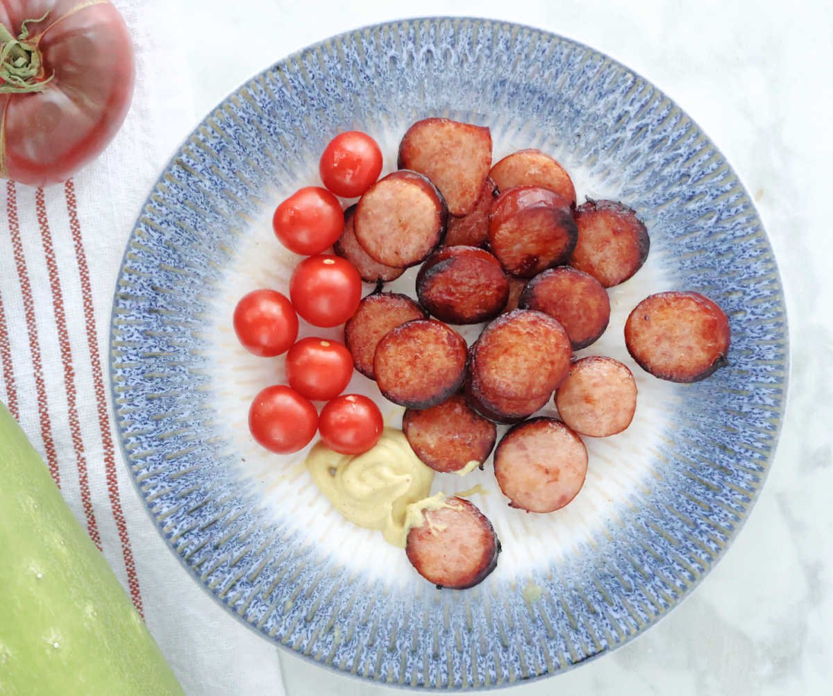 Air fried Kielbasa in coins, with fresh cherry tomatoes and Dijon mustard.