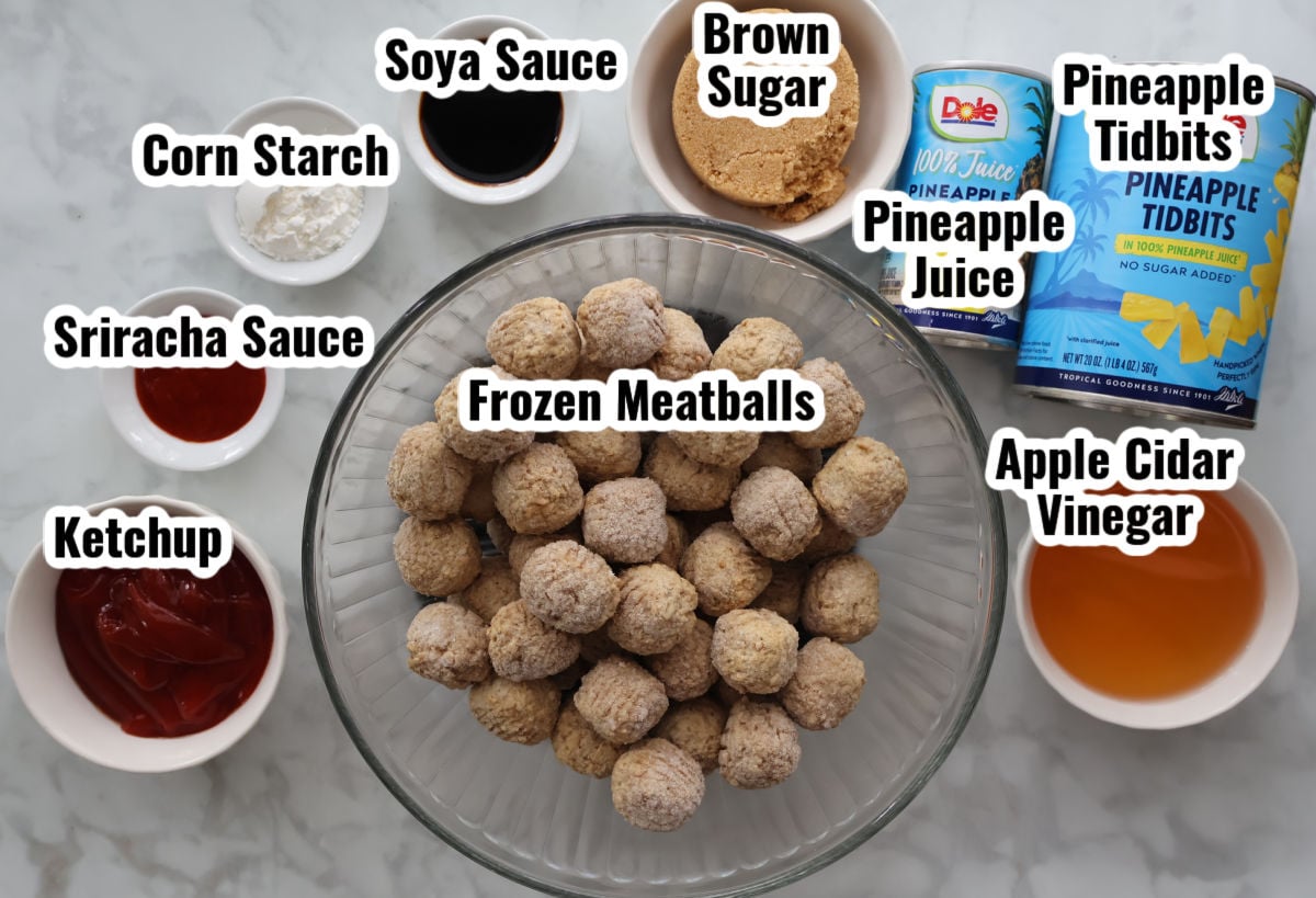 Ingredients for homemade sweet and sour sauce on meatballs.  Includes frozen meatballs pineapple tidbits, pineapple juice, apple cider vinegar, brown sugar, soya sauce, corn starch sriracha sauce and ketchup.