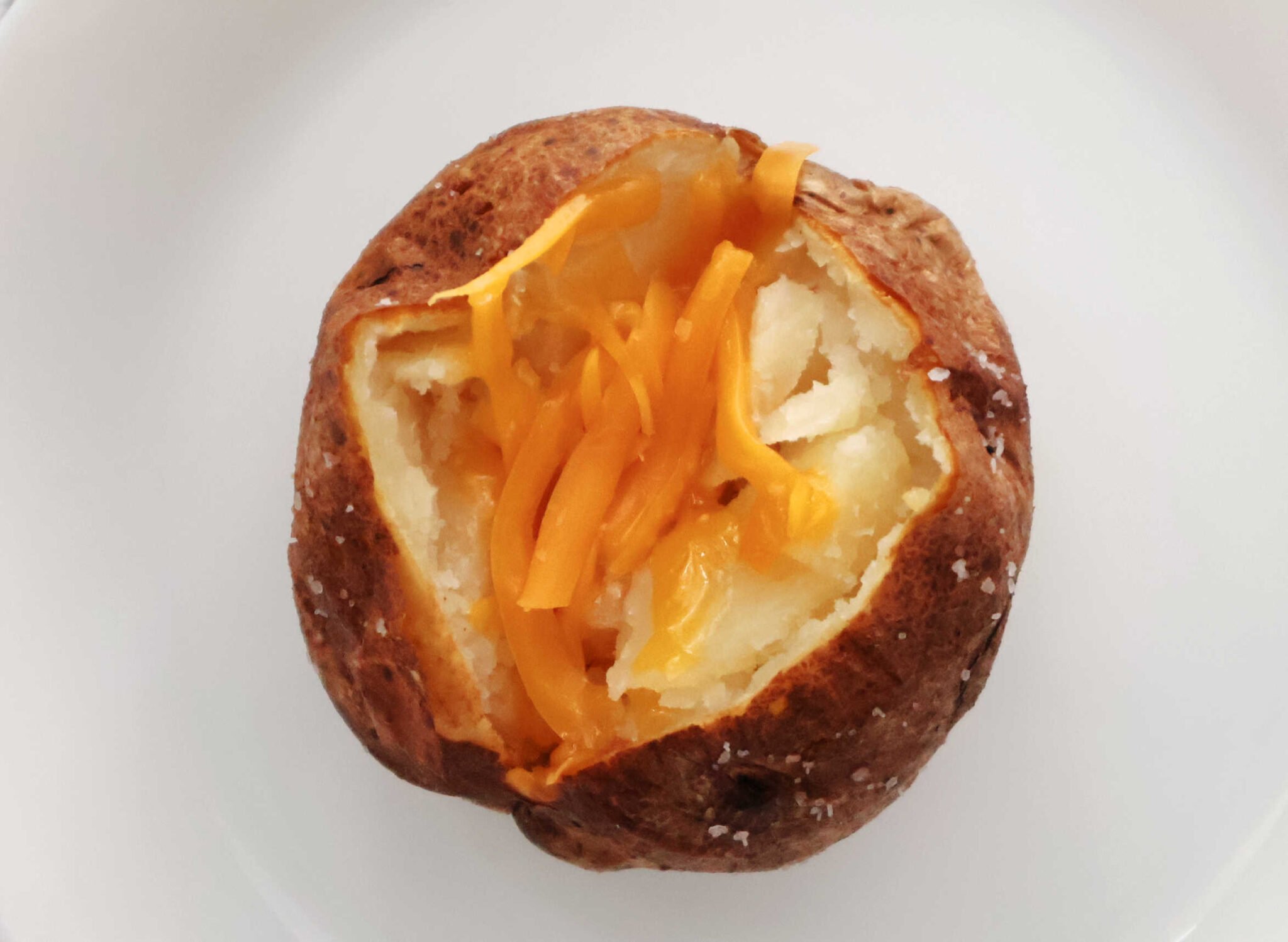 air fryer baked potato with cheddar cheese.