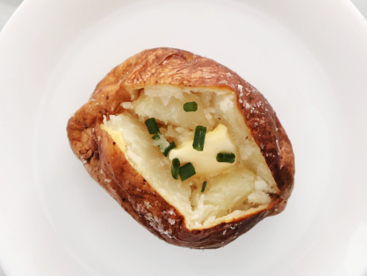 traditioanl baked potato with butter, salt and some chives.