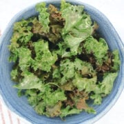 air fried kale pieces in a blue bowl