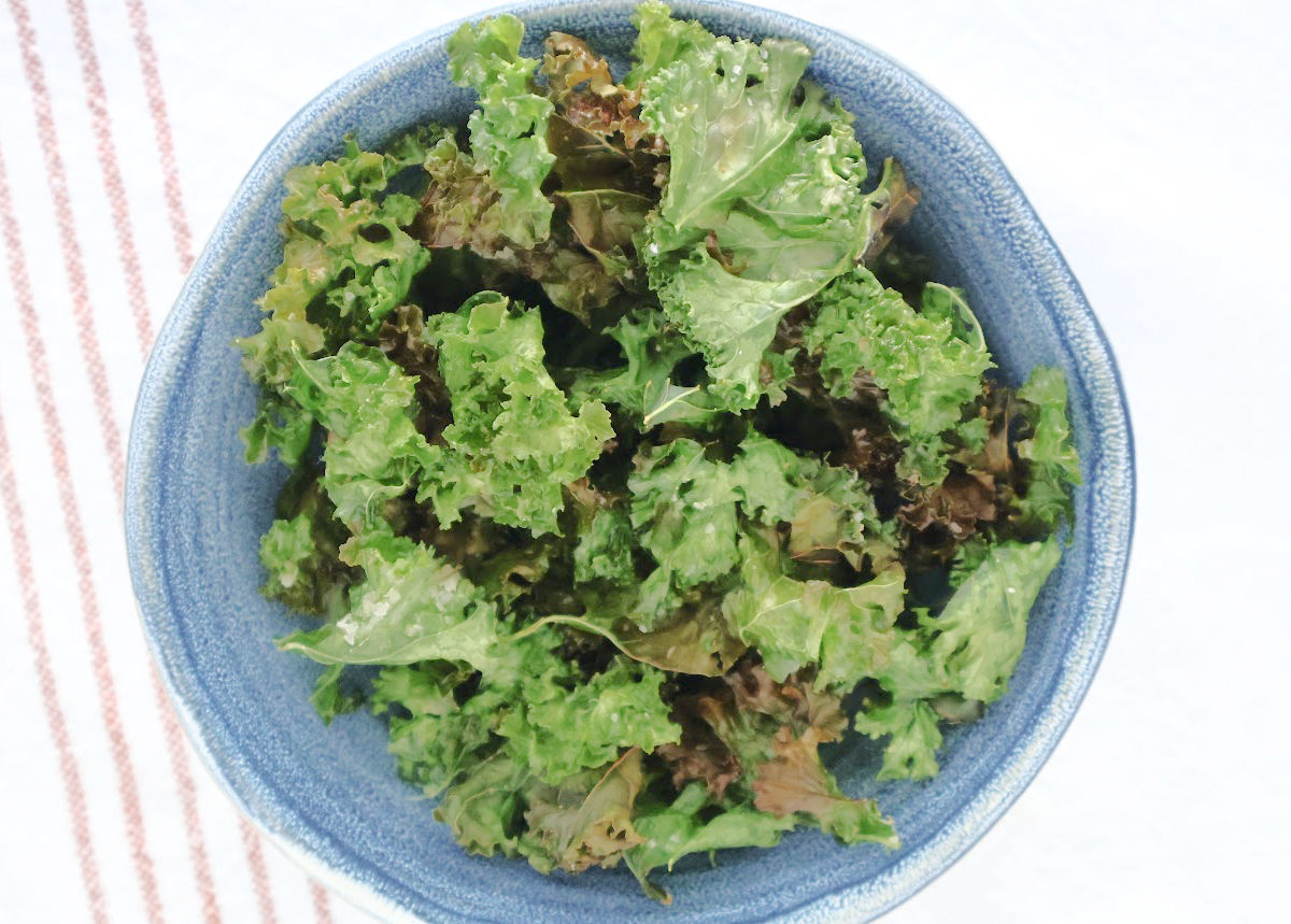 air fried kale pieces in a blue bowl