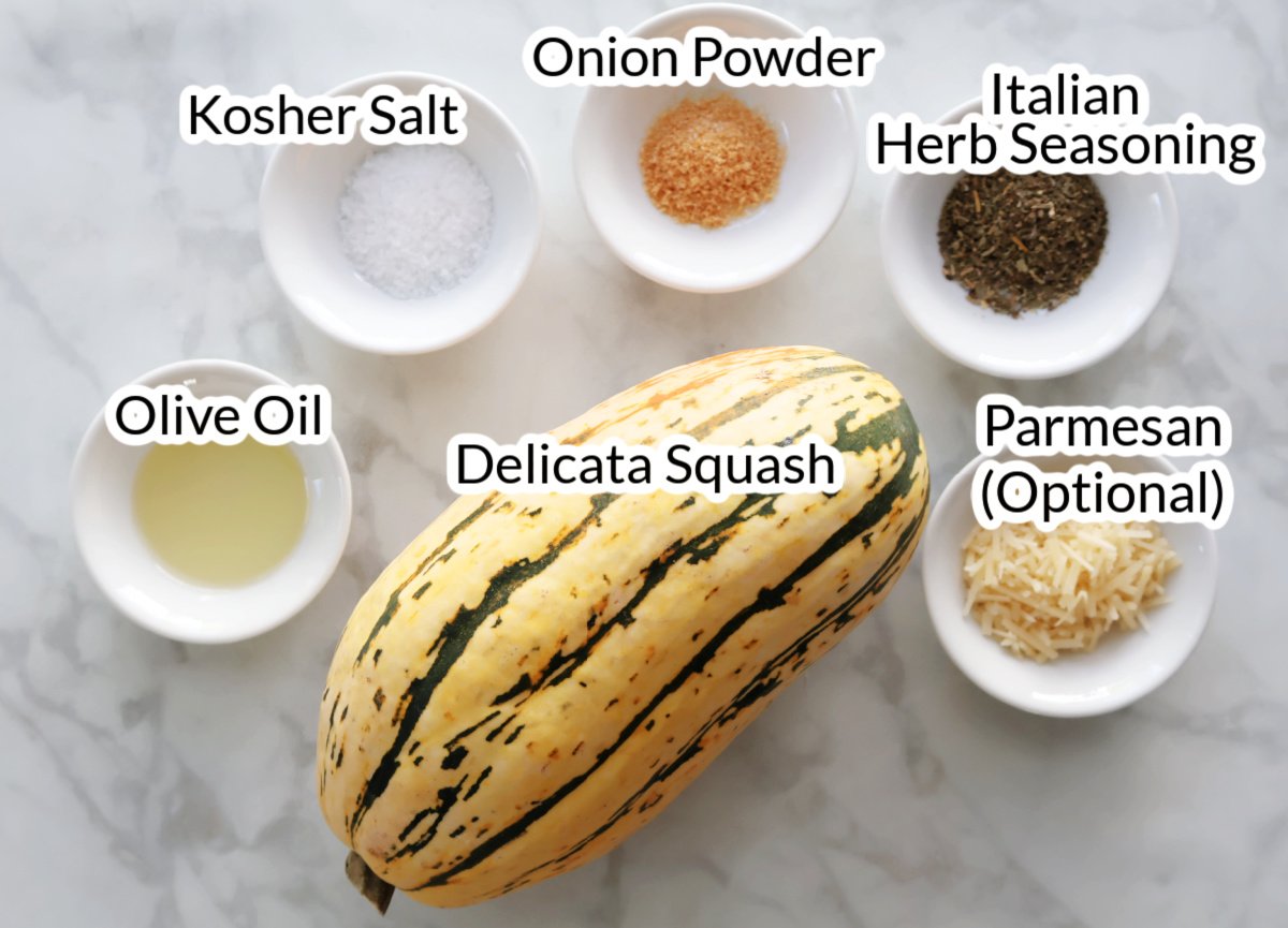 Ingredients for delicata squash made in the air fryer.  They are deliata squash, olive oil, kosher salt, onion powder, herb seasoning, optional parmesan.