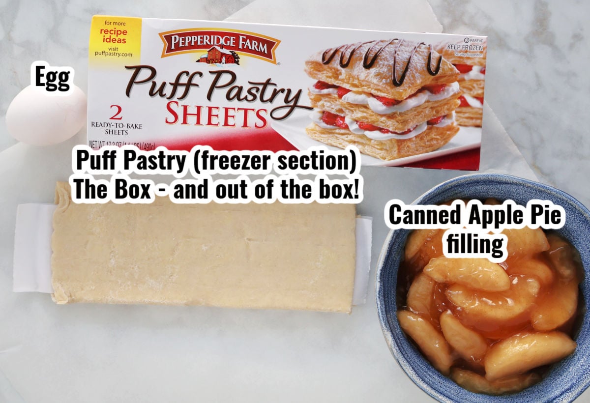 Apple Strudel ingredients include frozen puff pastry with the box it comes in, canned apple pie filling in a bowl and an egg. 