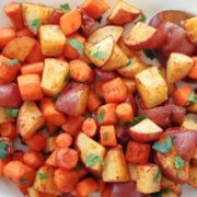 Red potatoes and carrots ready to be served. They are oven browned with the smoked paprika seasoning visible.