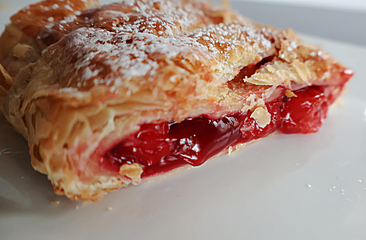 cherry pie filling showing in the puff pastry.