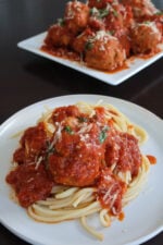 ricotta meatballs on top of spagetti with tomato sauce.