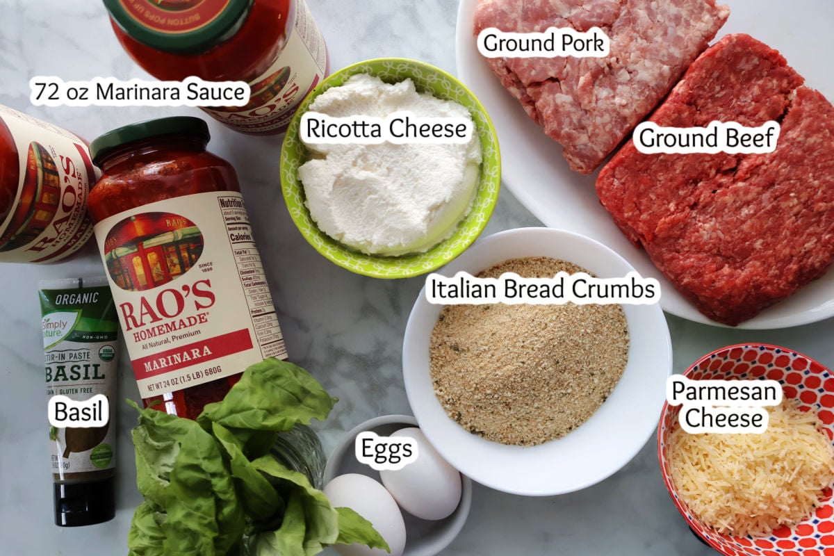 Ingredients for ricotta meatballs in a bowl. Ingredients include ground pork, ground beef, ricotta cheese, parmigiano cheese, Italian bread crumbs and eggs.