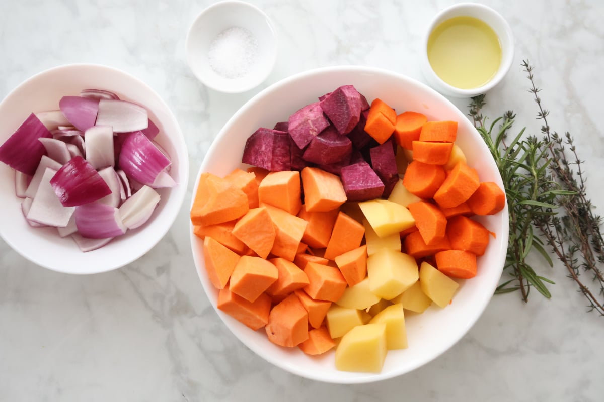 chopped root veggies including potatoes, sweet potatoes, carrots and red onion.