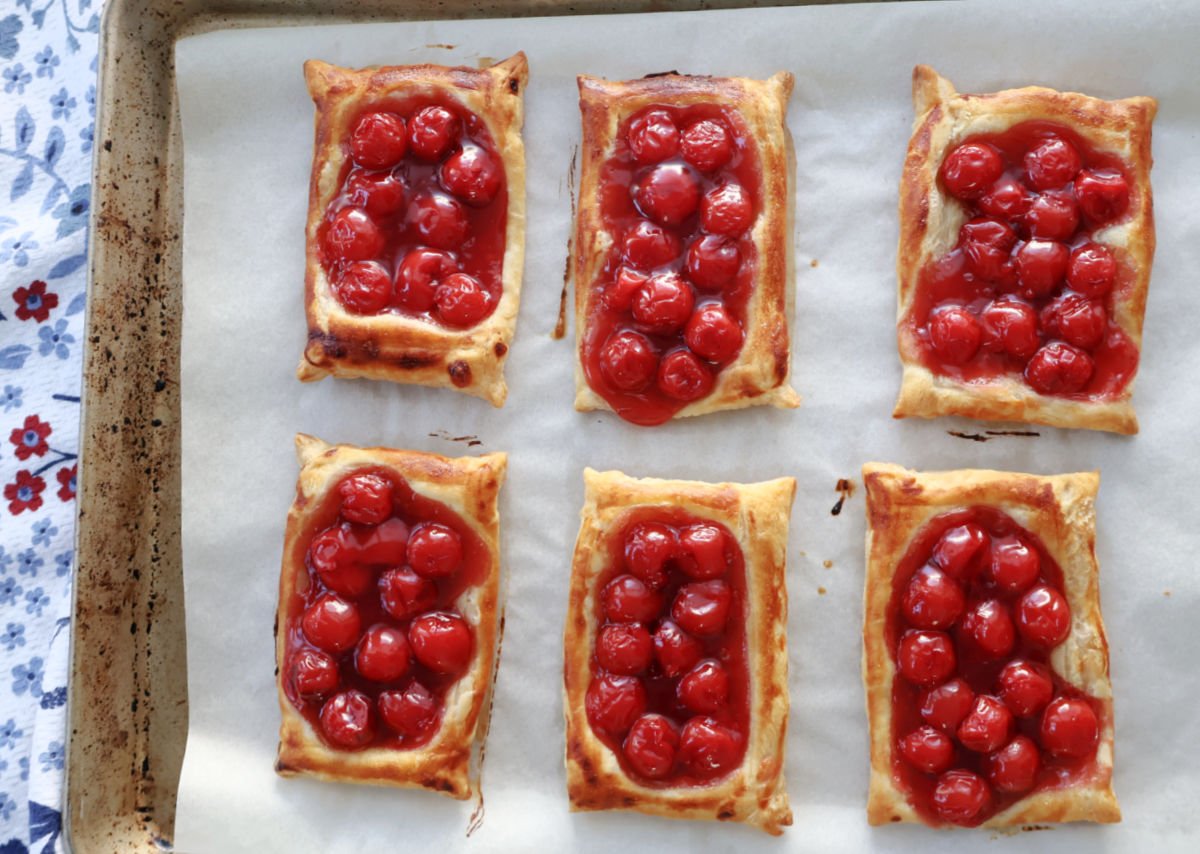 Freshly baked cherry danishes made with puff pastry and cherry pie filling.