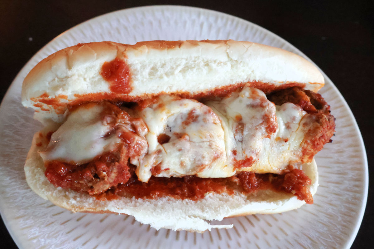 meatball sub with marinara sauce and melted provolone cheese.