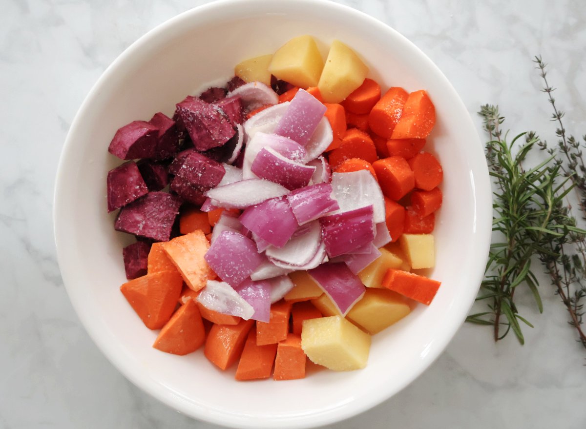 Chopped root veggies including potatoes, sweet potatoes, carrots and red onions