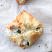 baked puff pastry containing a ham and cheese mixture with spinach.