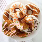Pumpkin spice donuts arranged on a white plate for serving